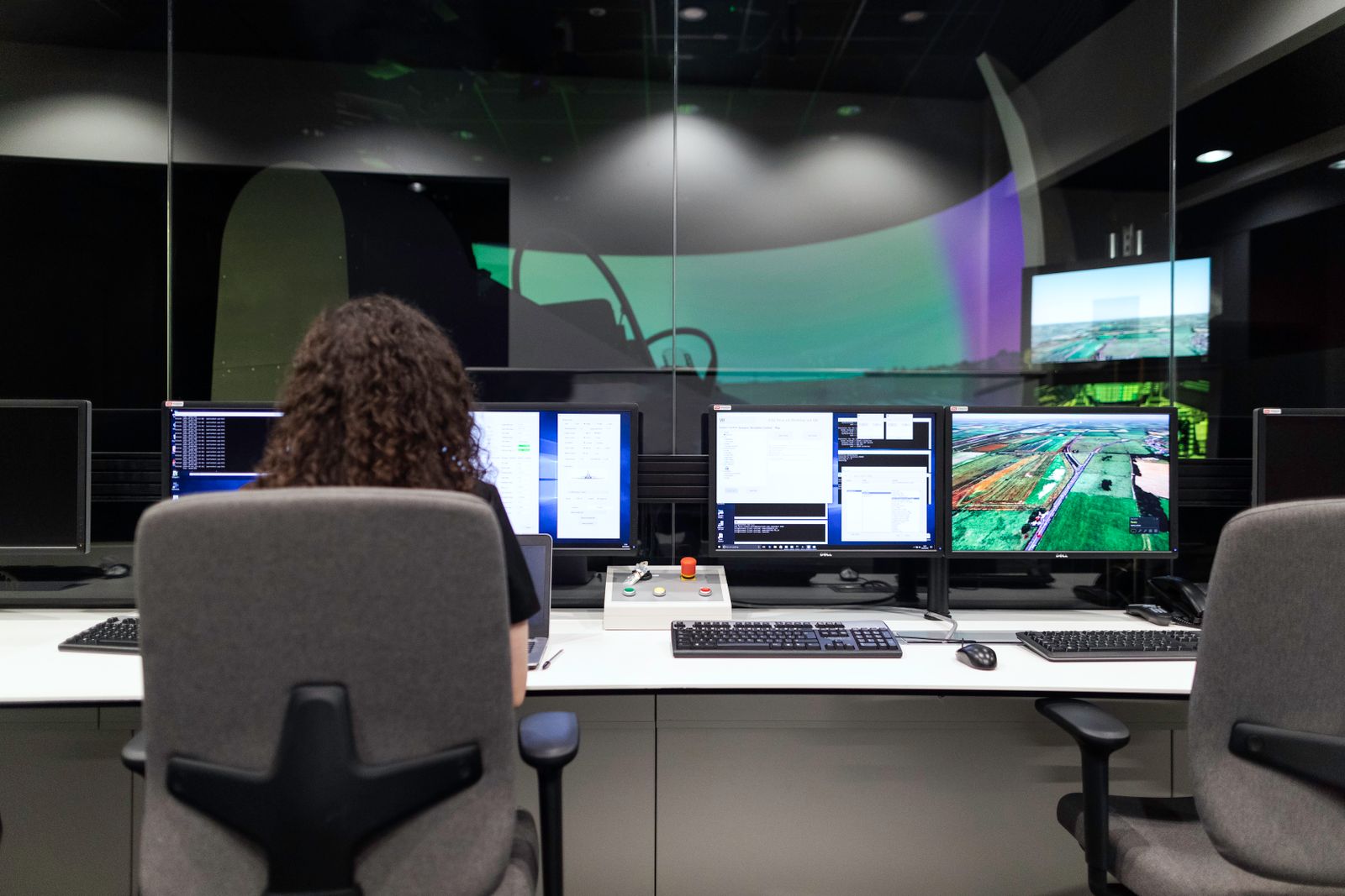 Operator reviewing live data across several screens